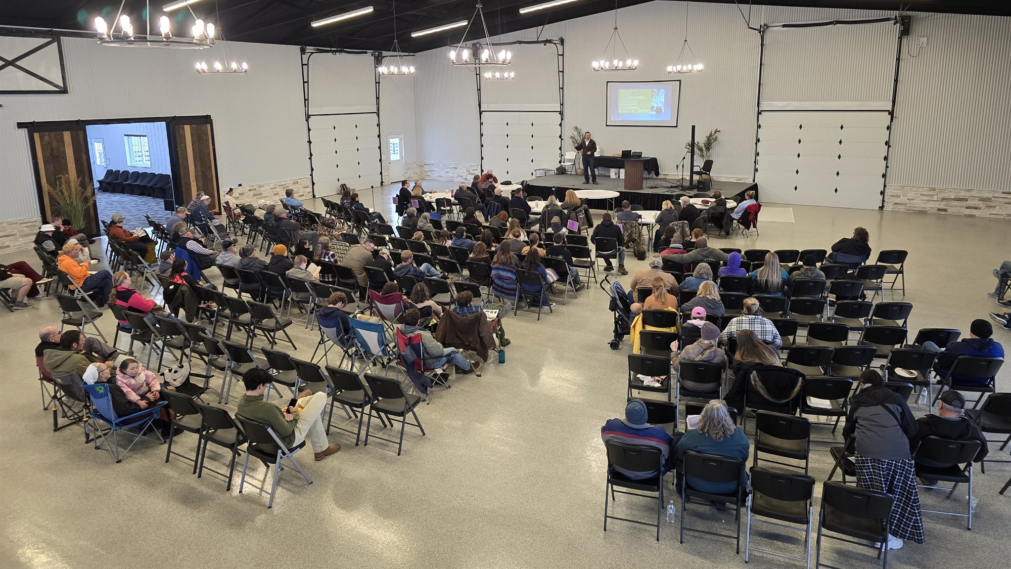 Jamon Mysliwiec speaking to a full hall at the Stables Homestead Summit